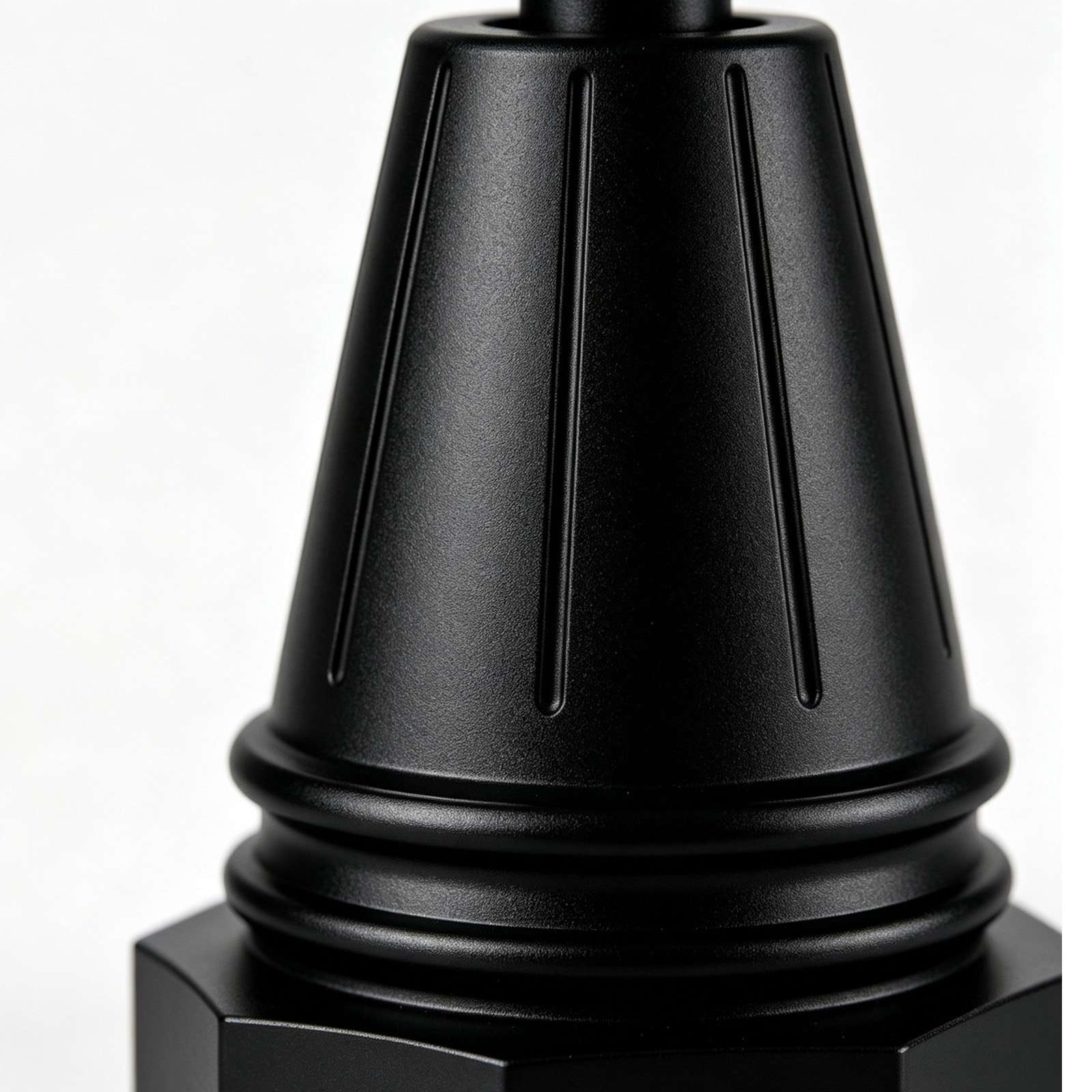 Close‑up of aluminum lamp base, matte black powder coating surface texture detail
