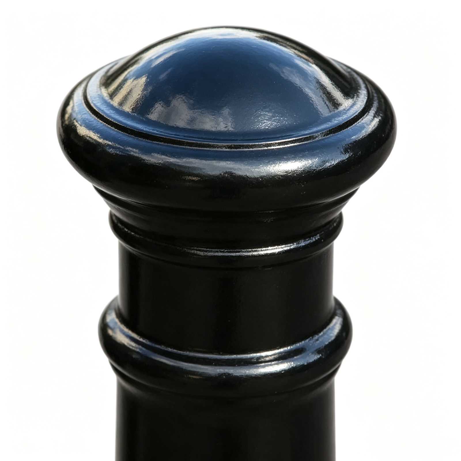 Dome top cap detail of black cast iron bollard