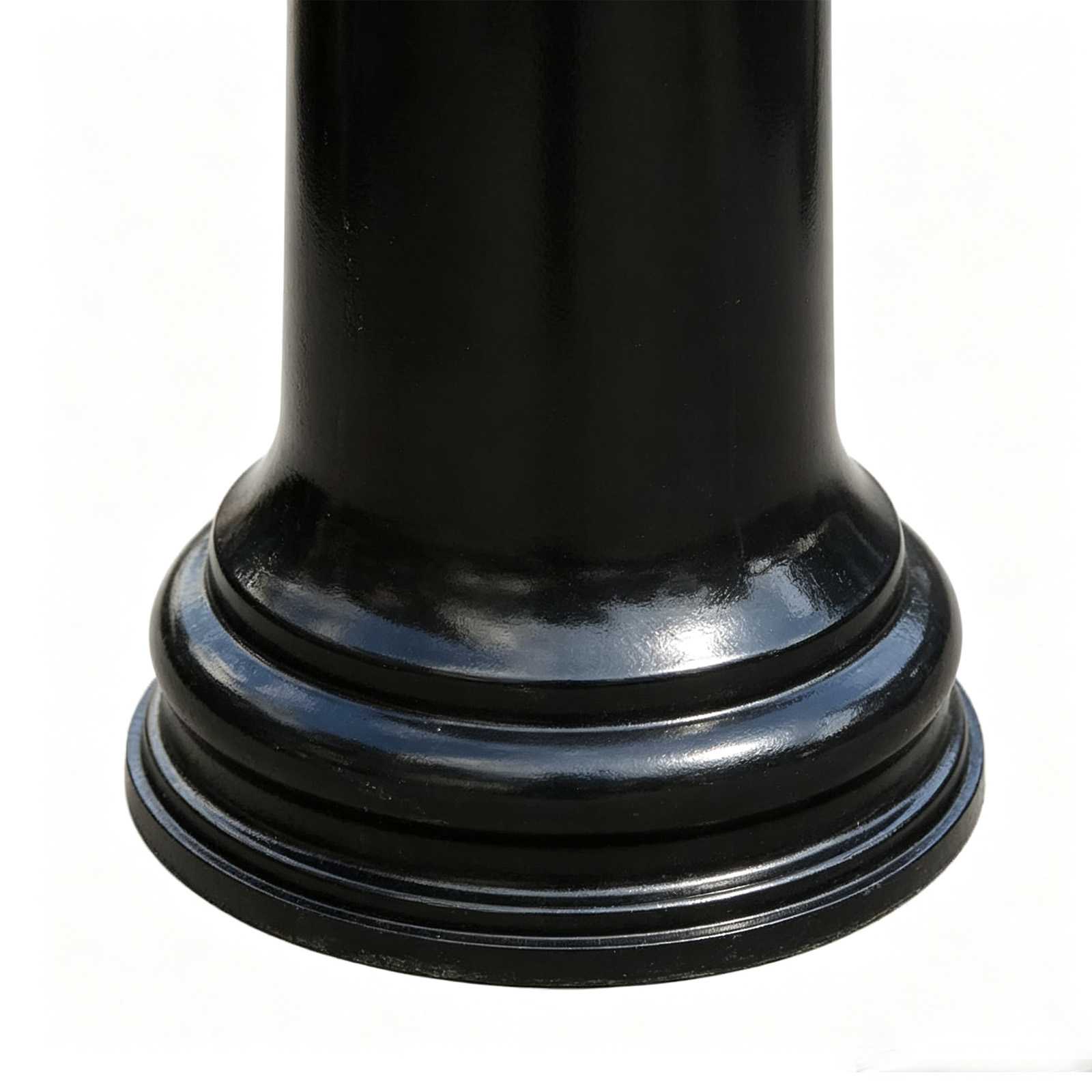 Close-up of ornate base of black cast iron bollard