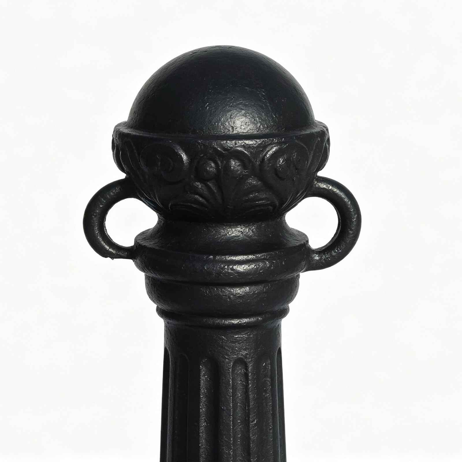 Close‑up of cast iron bollard top, sphere finial, side rings and carved patterns